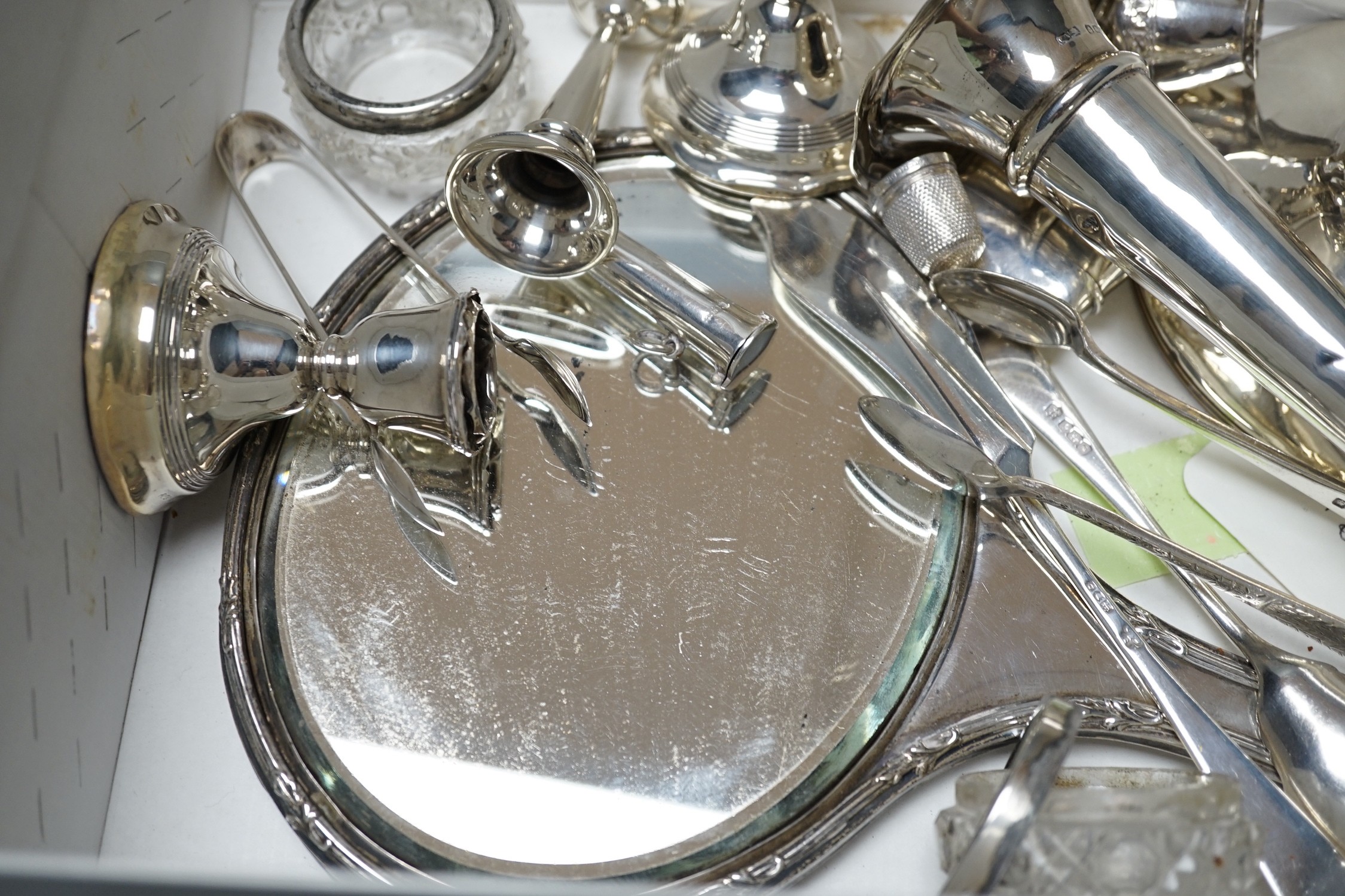 Sundry small silver items including a hand mirror, capstan inkwell, flatware, vesta case, mounted glass salts, dwarf candlesticks, condiments, posy vase, etc.